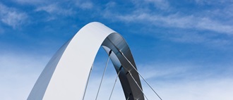 Bridge arch against blue sky
