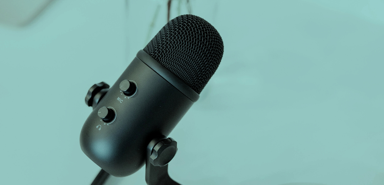 Podcast microphone on blue-green background